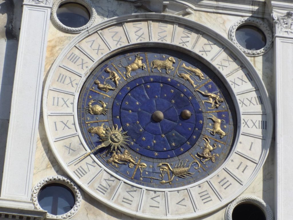 Detailed view of the zodiac clock in Venice's Piazza San Marco, showcasing intricate astrological symbols.