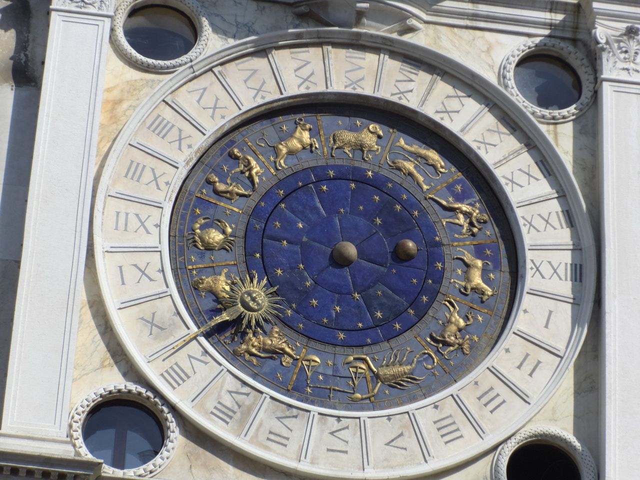 Detailed view of the zodiac clock in Venice's Piazza San Marco, showcasing intricate astrological symbols.